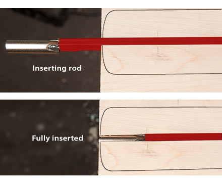 Sliding the truss rod into the end of the channel.