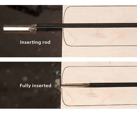 Sliding the truss rod into the end of the channel.